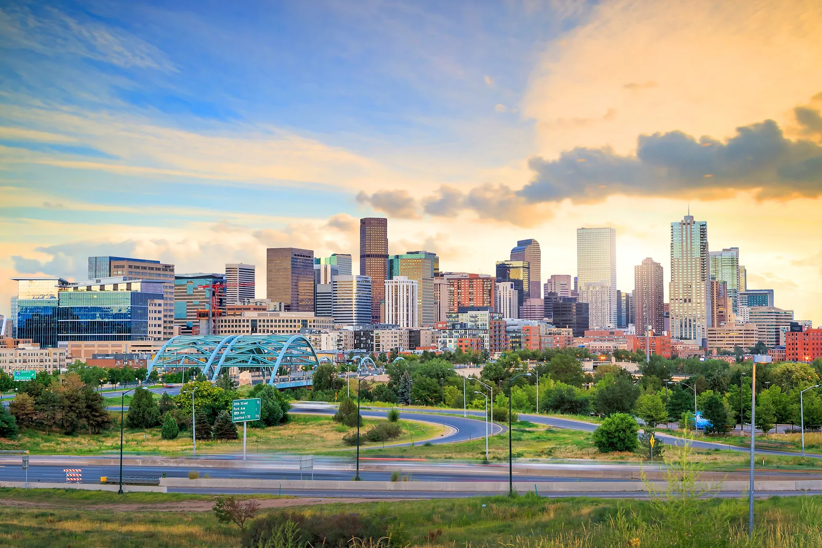 Denver skyline at twilight with the Speer Boulevard bridge in the foreground